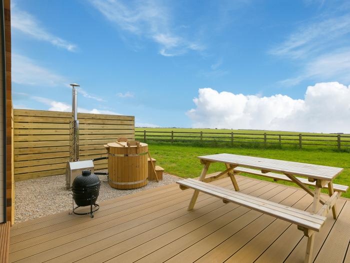 Sun Rise, St Buryan, Cornwall. Sleeps two guests in a studio-style layout. Hot tub. Enclosed garden.
