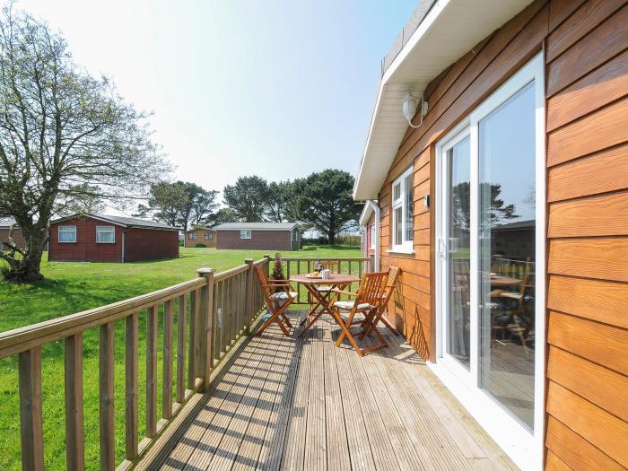 Little Trebah in Atlantic Bays Holiday Park in Cornwall. Decking with furniture. On-site facilities.