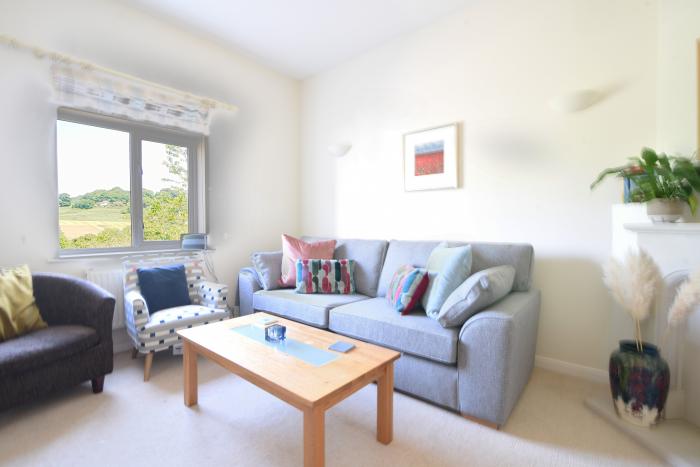 6 Barnes Meadow in Uplyme, Devon. Close to a beach. In an AONB. Dog-friendly. Three-storey. Parking.