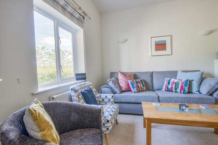 6 Barnes Meadow in Uplyme, Devon. Close to a beach. In an AONB. Dog-friendly. Three-storey. Parking.