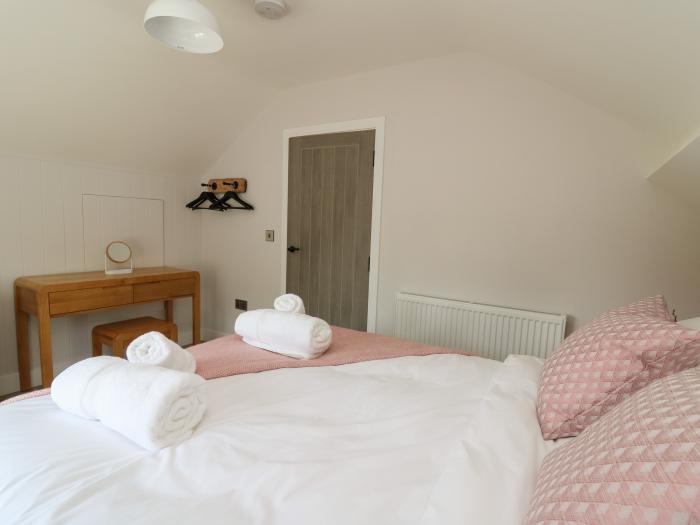 Rhiwmynach is near Aberystwyth, in Ceredigion. Two-bedroom property with woodburning stove. Hot tub.