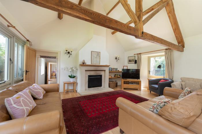 The Long Barn, is near Tetbury, in Gloucestershire. Eight-bedroom barn conversion set in AONB. Pets.