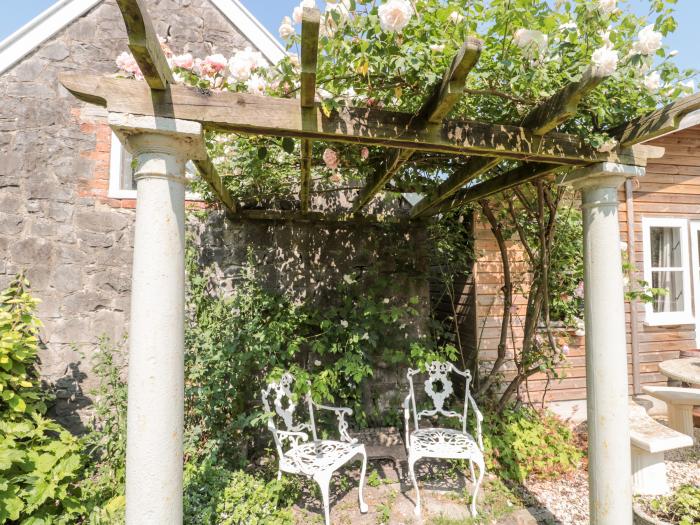 Little Wick is in Lympsham, Somerset. Two-bedroom stable conversion. Enclosed, pretty garden. Family