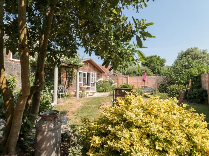 Little Wick is in Lympsham, Somerset. Two-bedroom stable conversion. Enclosed, pretty garden. Family