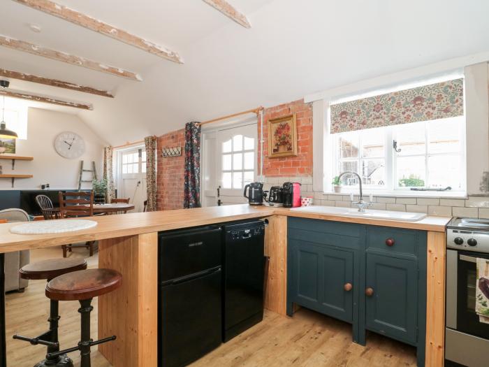 Little Wick is in Lympsham, Somerset. Two-bedroom stable conversion. Enclosed, pretty garden. Family