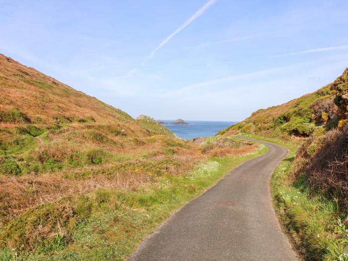 The Riblows nr St Just, Cornwall. Three-bedroom farmhouse with sea views. Hot tub and pretty garden.