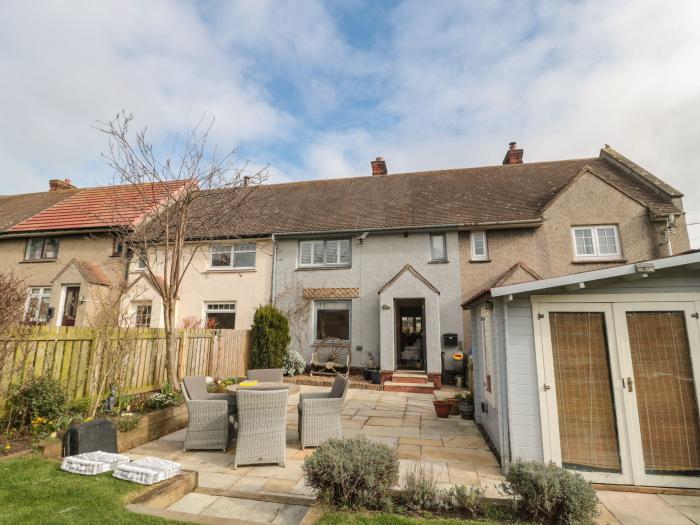 Coast Cottage, Bamburgh, Northumberland. Two-bedroom home resting near the beach and amenities. Pets