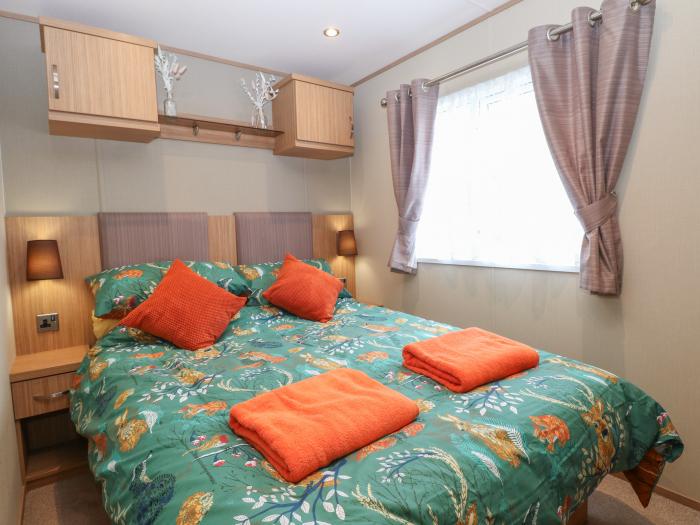 Stanley's Lodge near Belton, Norfolk. Off-road parking. Enclosed decking with furniture. Three beds.