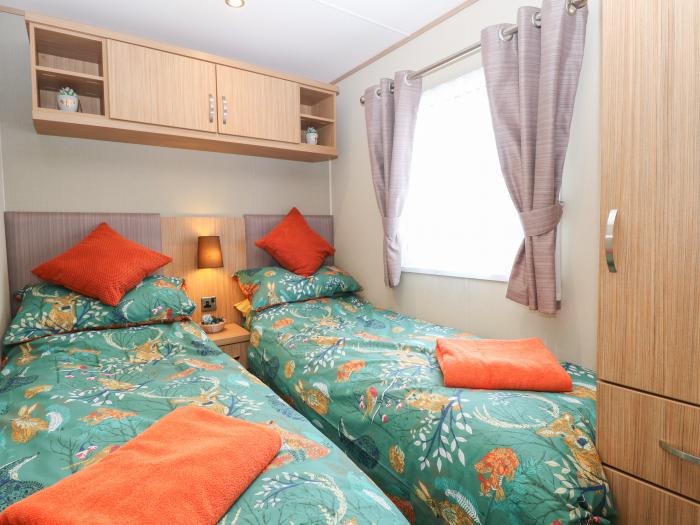 Stanley's Lodge near Belton, Norfolk. Off-road parking. Enclosed decking with furniture. Three beds.