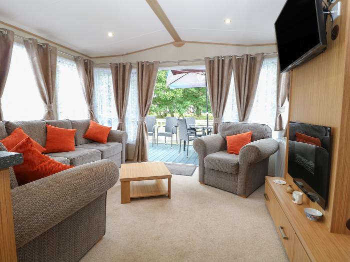 Stanley's Lodge near Belton, Norfolk. Off-road parking. Enclosed decking with furniture. Three beds.