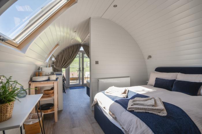 Cedar, located near Charmouth, Dorset. Two-bedroom pod, enjoying rural views. Pet-friendly. Stylish.