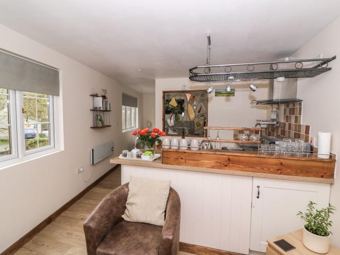 Ty Barddu near Newcastle Emlyn in Carmarthenshire. Elevated, wooden-clad cottage nestled in a valley