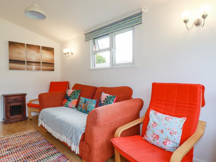 Chalet 208 in St Merryn, Cornwall. Two-bed lodge, with garden and open-plan living. Family-friendly.
